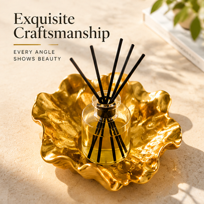Top angled view of the reed diffuser showing the rippled gold-toned base and black reeds