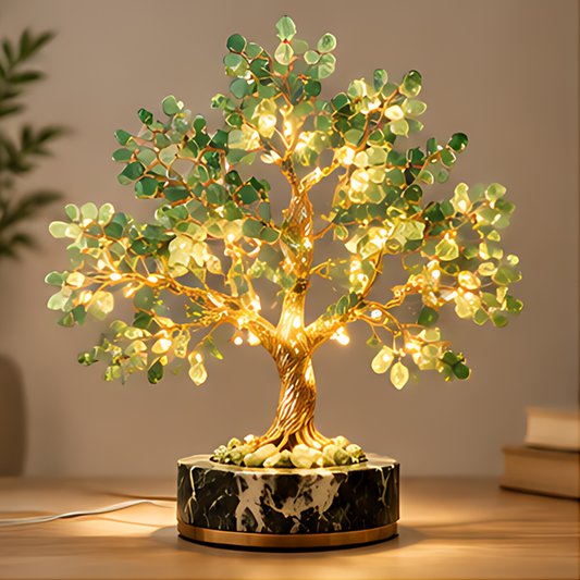 Illuminated decorative tree with green stone leaves, gold-toned branches, and a black-and-white patterned base